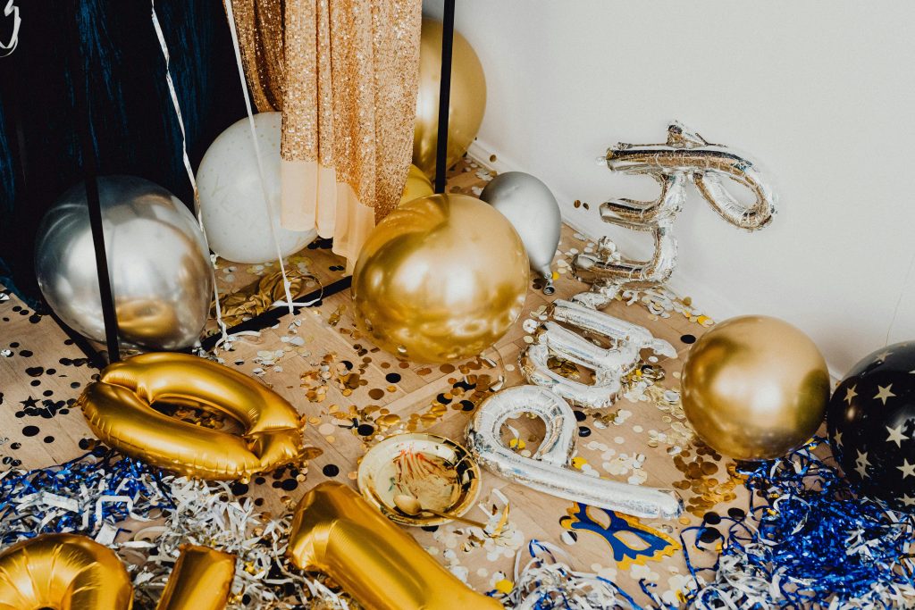 Vibrant indoor party scene with balloons and confetti creating a lively celebration atmosphere.